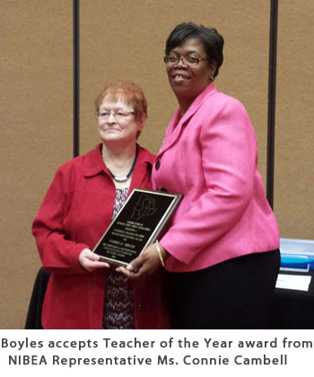 Boyles accepts Teacher of the Year award from NIBEA Representative Ms. Connie Campbell
