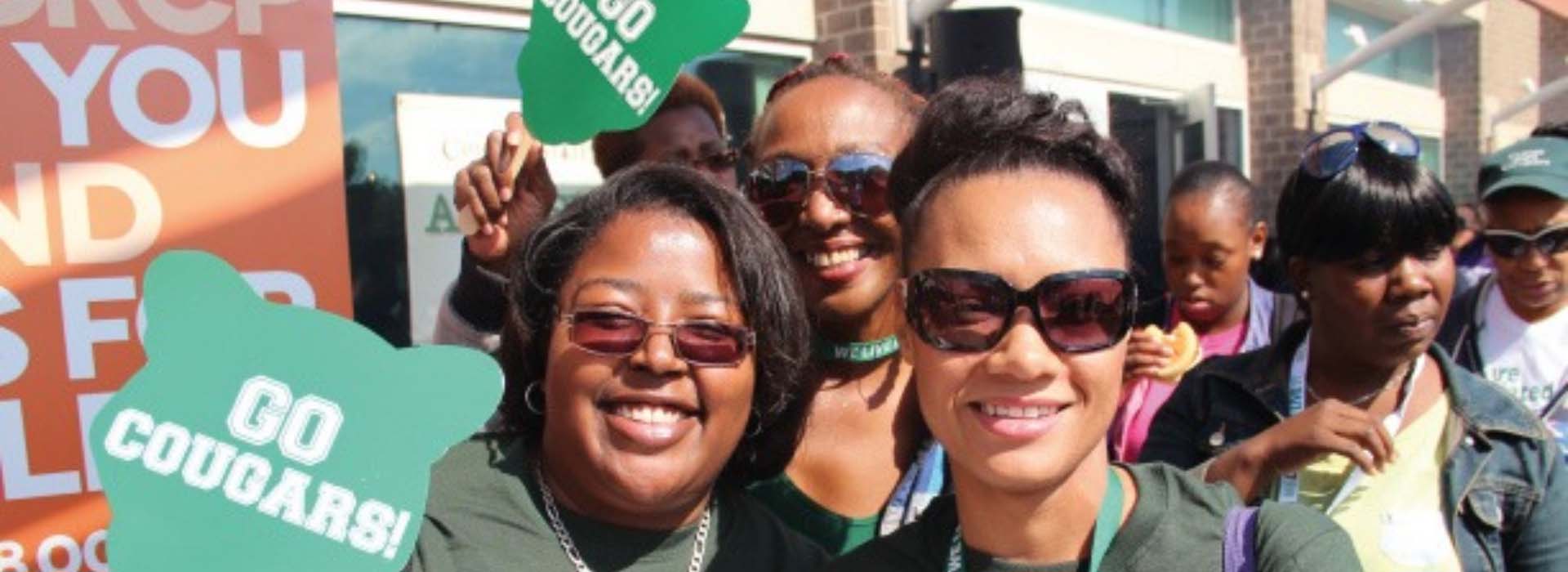 Two CSU students at an outdoor event wearing CSU gear
