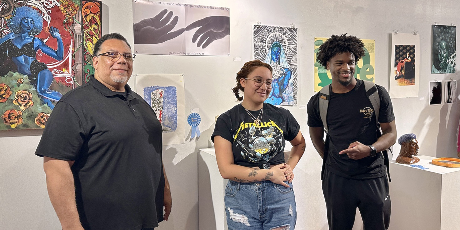 Professor with two students at gallery exhibition