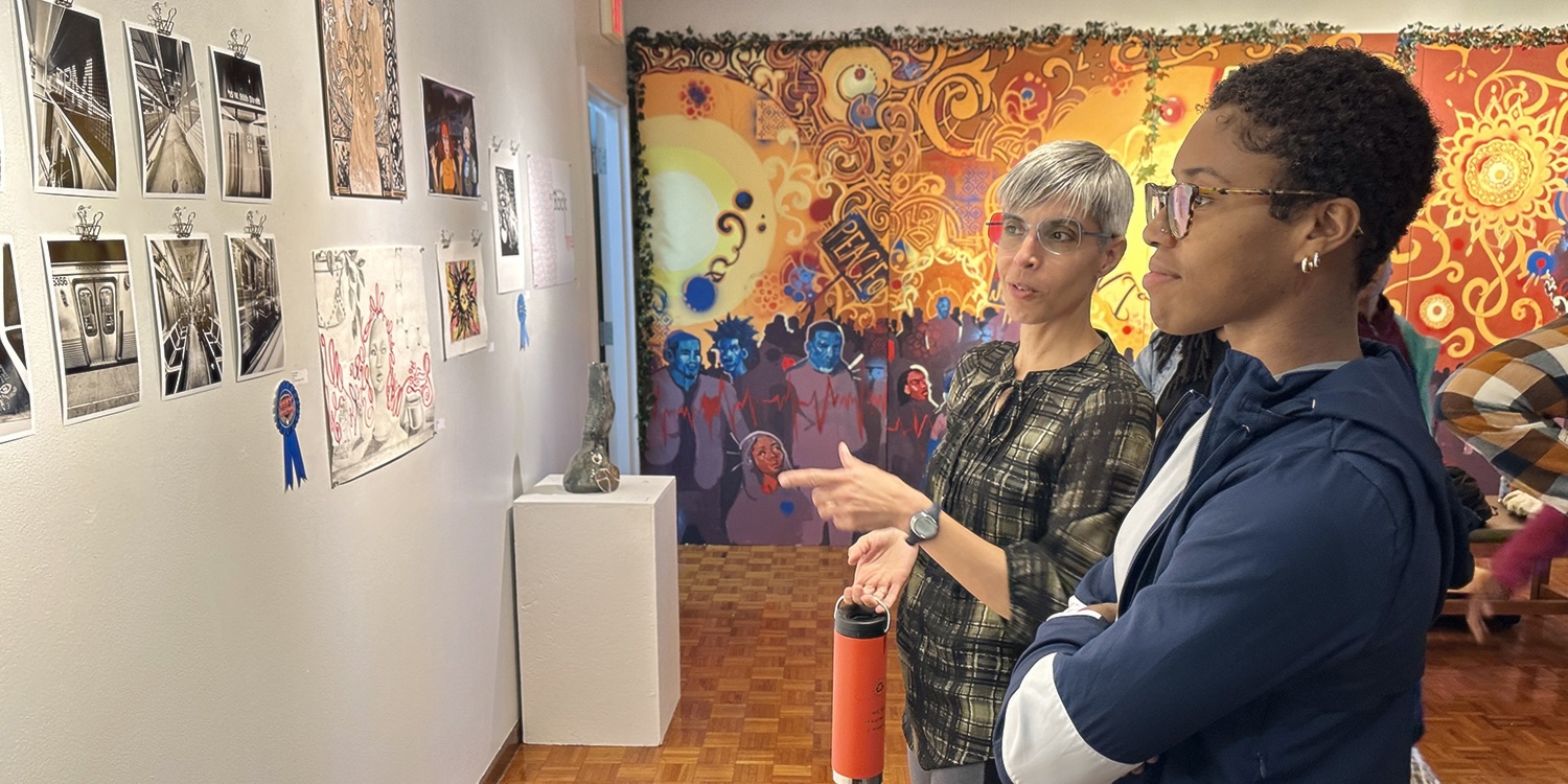 Professor and student discussing artwork