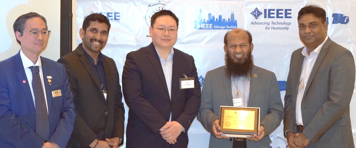 Dr. Mohammad Salam poses for a photo with four others as he receives the Outstanding Student Branch Advisor award.