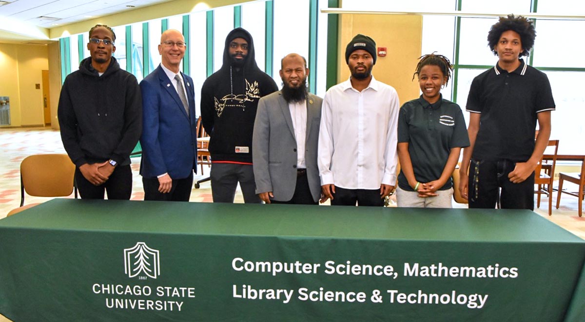 At the STEM-Day Hackathon, a group of Chicago State University students pose with Dean Mark Smith and CIMST chair Dr. Mohammad Salam.