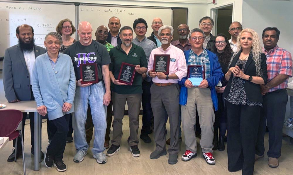 Doctors Attele, Gomez, Chern and Hrozencik take a group photo with other faculty and staff members while holding their plaques.