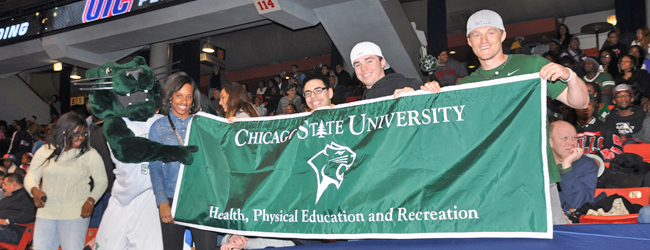 Students actively participating at a CSU basketball game and interacting with the team mascot (Cougar) in the JDC gymnasium