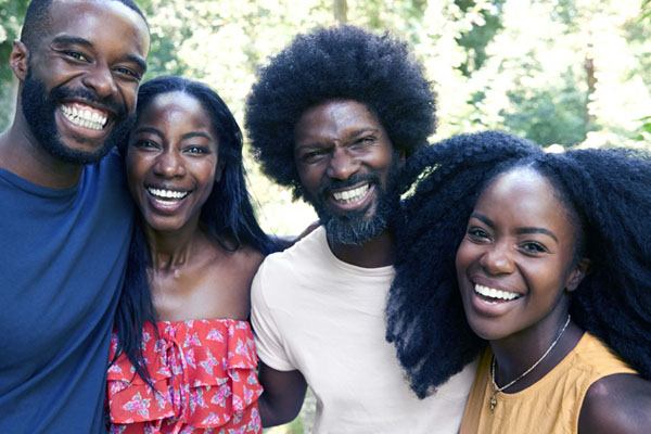 Four Alumni Smiling